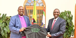 President William Ruto (right) and ACK Archbishop display a t-shirt after a meeting at State Hosue on March 16, 2023. 