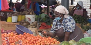 undated image of a food vendor arranging tomatoes