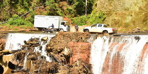 Vehicles pass along a flooded Meru-Githongo-Chogoria road.