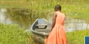 Virginia Aoko with a boat in Busia County.