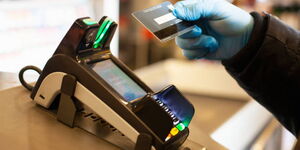 A Visa card used to pay for goods at a supermarket
