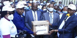 Suna East MP Junet Mohamed (left), and BBI Secretariat Co-Chair Dennis Waweru (right) submit signatures to IEBC Chair Wafula Chebukati (centre) at IEBC headquarters in Nairobi on December 10, 2020