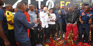 Wazito FC owner Ricardo Badoer (centre) pops champagne when he officially unveiled the team bus in May 2019