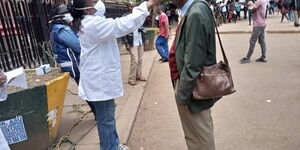 A photo of medics screening a man at National Archives, Nairobi.