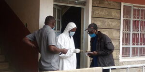Residents surround the man's house in Umoja