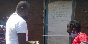 ODM's Director Communications Philip Etale (left) launching a structure for a widow in Lugari on May 30, 2020.