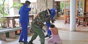 Police officers clobber Mlango Kubwa MCA Patricia Mutheu at City Hall on Tuesday, July 28.