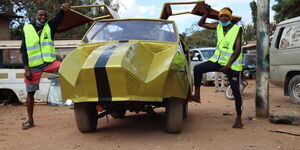 Nassir Kichinda (left) and Ferdinand Mbashu (right) with their car with butterfly doors.