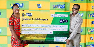 Patrick Macharia (right) receiving a cheque of Ksh15 million