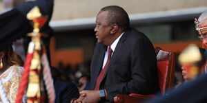 Former President Uhuru Kenyatta watches on as President Wiliam Ruto reads his speech at Kasarani after being sworn in as Kenya's fifth president on September 13, 2022