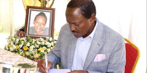Wiper Leader Kalonzo Musyoka signs the condolence book during the burial of Johnson Muthama's daughter on Monday, May 2, 2022.