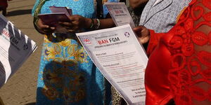 Women hold FIDA Kenya-Anti FGM handouts. Over 500 teenage girls have been forced to undergo the outlawed practice between March and June 2020.