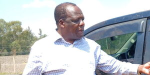 Former Kakamega Governor Wycliffe Oparanya analysing damage to his vehicle during the Wednesday, July 132 demonstrations.