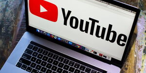 YouTube logo displayed on a laptop screen