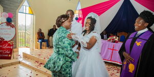  Pastor Dorcas Rigathi hugs Fidellis Njeri, as her husband Simon Kihara and Rev Winnie Ndungu look on at PCEA Church Raiyani in Githunguri, Kiambu County.