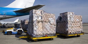 A cargo plane unloading goods at an airport