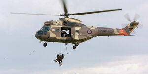 A Kenya Air Force Plane in the air.