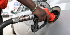 A man fueling a car at a petrol station