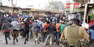 A police officer chases protesters away in a past incident