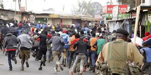A police officer chases protesters away in a past incident.