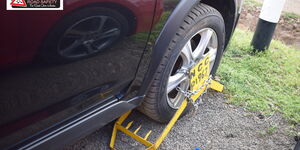 A photo of a clamped car