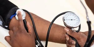 A doctor checking a patient's blood pressure levels