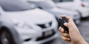 A hand holding a car anti-theft lock system.