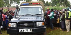 A photo of a police vehicle at a past crime scene