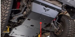A photo of an arrow pointing at a skid plate fitted on an off-road vehicle