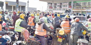 A photo of boda boda riders at a petrol station