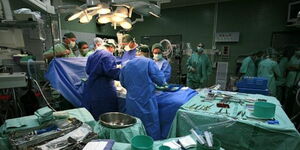 A photo of several doctors and nurses inside an operating room