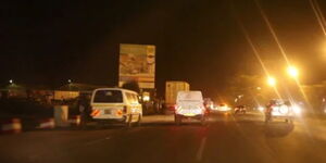 A photo of vehicles on the highway at night in Kenya