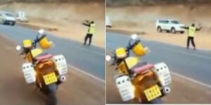 A screengrab of a boda rider directing traffic on a Kenyan road