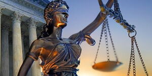 A statue holding the symbol of justice.