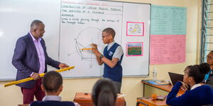 A teacher interacts with a student at Riara Springs Primary School, in Nairobi 