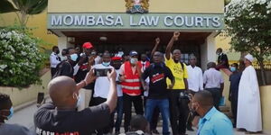 Activists protest outside Milimani Law Courts on Monday, February 21, 2022
