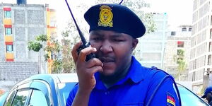 Comedian Alex Mathenge using a two-way radio device