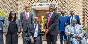 An undated photo of National Assembly speaker Moses Wetang'ula handing a trophy to his brother, Westlands Member of Parliament Tim Wanyonyi