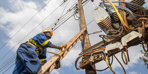 An engineer carries out maintenance on power lines.