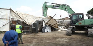 An excavator demolishing a building in Industrial Area.