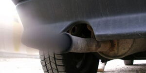 A photo of a vehicle's exhaust pipe emitting smoke. 