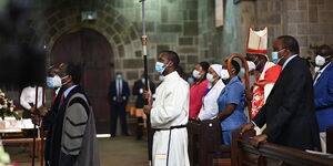 resident Uhuru Kenyatta (standing in pew) as Archbishop Jackson Ole Sapit processes at the start of a service in All Saints’ Cathedral, Nairobi, for a service to mark the 50th anniversary of the Anglican Church of Kenya.
