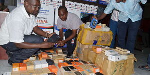 Officers from the anti-counterfeit agency inspecting counterfeit products in 2019