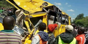 Area residents surround a school bus involved in an accident on Friday May 5, 2023