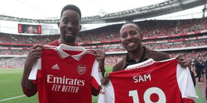 Arsenal fans, Adrian Ntwatwa (left) and Sam Ruguna hold their custom Arsenal jerseys at the Emirates Stadium, London on May 14, 2023.  