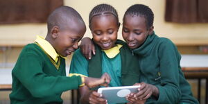 A group of students using an ATC Kenya tablet in class, March 2025.