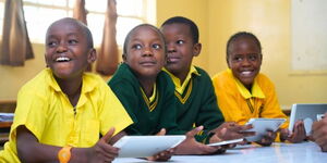 A group of students using an ATC Kenya tablet in class, March 2025.