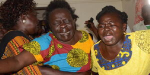 Millicent Odhiambo (centre) who is the mother of late Wendani MCA Cyrus Omondi is consoled by relatives after she was overcome by grief at her Wendani home after receiving news of the ward rep’s death on Wednesday, February 12