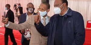 President Uhuru Kenyatta and Embakasi East MP Paul Ongili aka Babu Owino on Friday, August 21, at KICC, Nairobi during the issuance of title deeds.