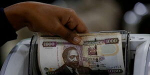 A bank teller in Kenya counting money.